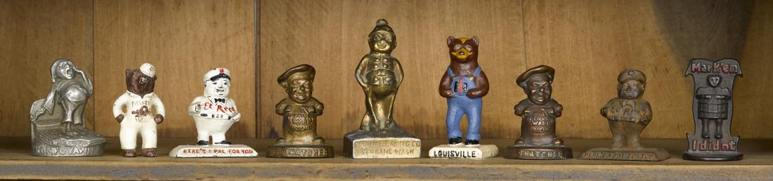 Nine cast iron figural advertising paperweights, to (1 of 1)