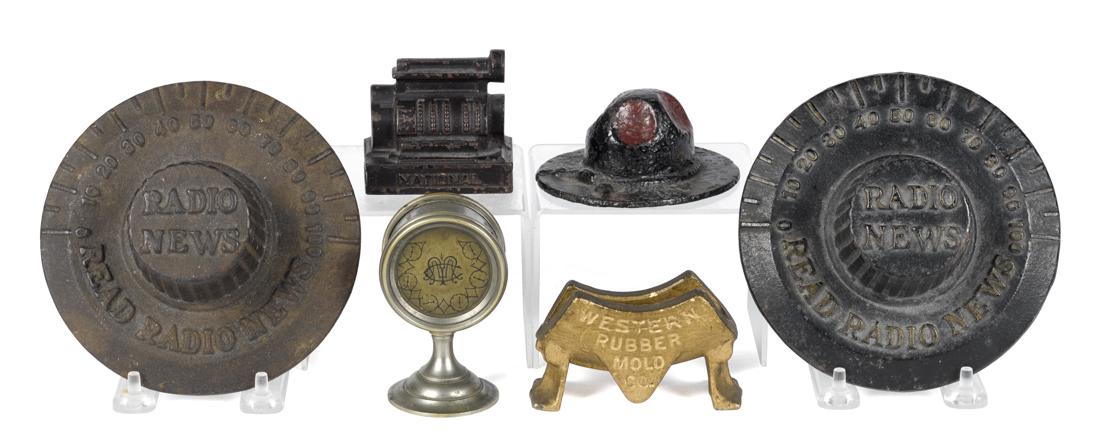 Six cast iron news and advertising paperweights, to (1 of 1)