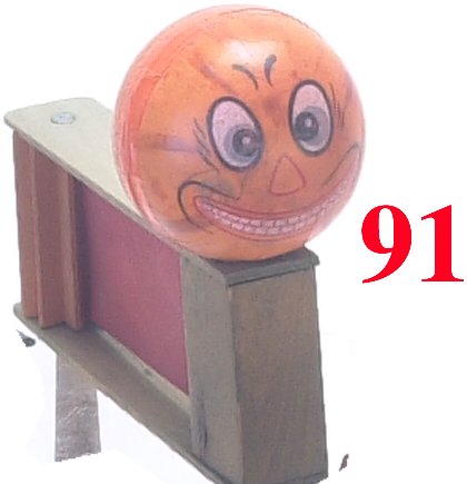 Jack-O'-Lantern face Ratchet: Jack-O'-Lantern face Ratchet-pressed cardboard head on wooden devise-very good to excellent (slight discoloration to face)-7" t.- Estimate: 75-100