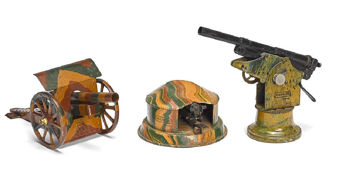 Three Marklin camouflage painted tin guns: Three Marklin camouflage painted tin guns, to include an anti-aircraft gun in turret, a field gun and a stationary gun, largest - 8'' l.
