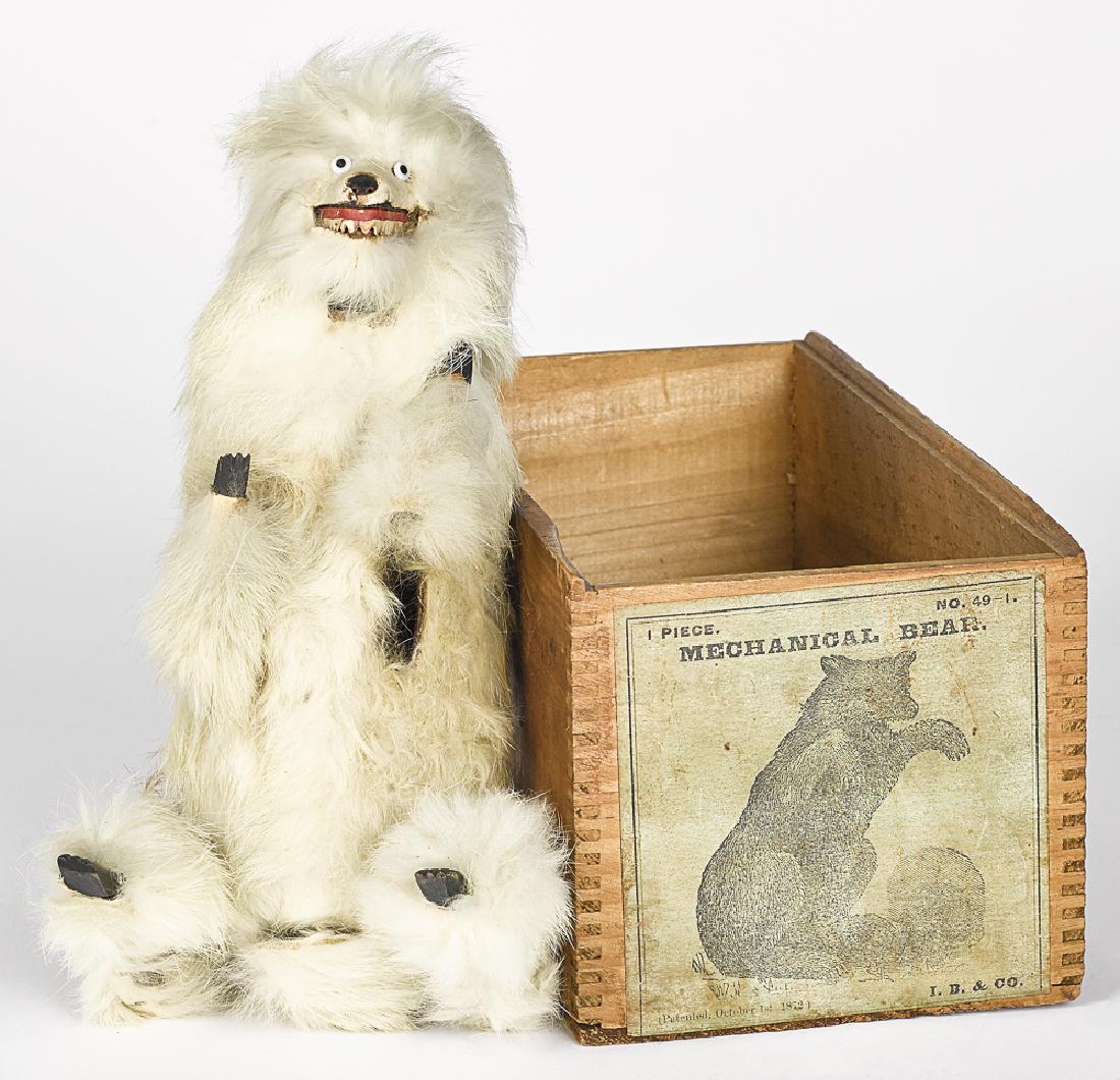 Ives, Blakeslee & Co fur clockwork mechanical bea: Ives, Blakeslee & Co. fur-covered clockwork mechanical bear, with the original box, having a wooden face, hands and feet, with paper teeth, 9'' h.