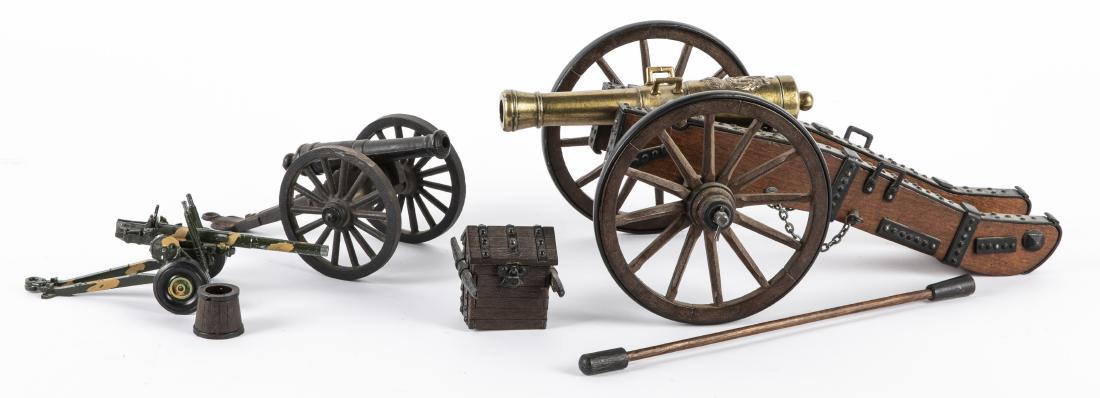 Three toy cannons: Three toy cannons, to include one with a brass barrel, one cast iron souvenir of Gettysburg and one Crescent Toy Co. camouflage field gun, largest - 15'' l.