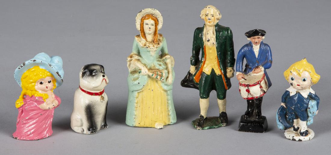 Six cast iron figural paperweights: Six cast iron figural paperweights, to include George and Martha Washington, a Revolutionary War drummer, a seated dog, and a young boy and girl, tallest - 4 1/2''.