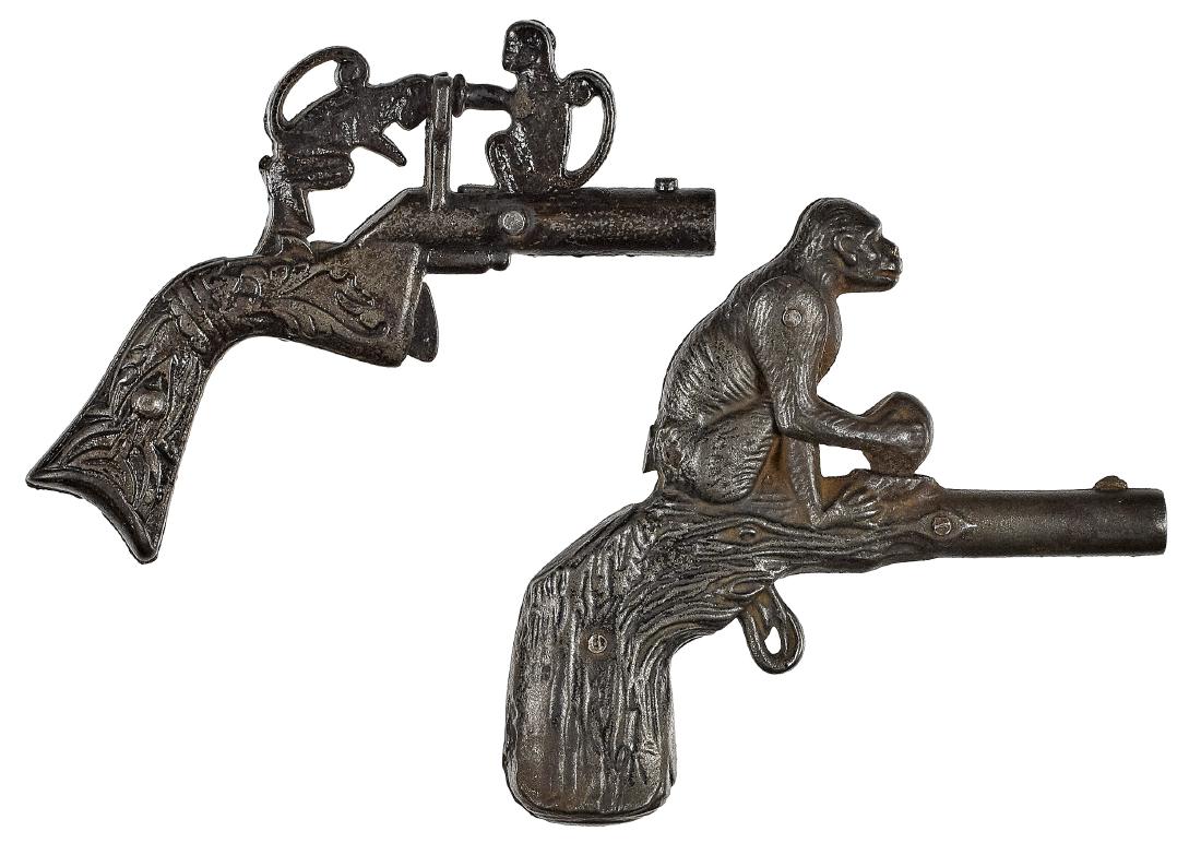 Two cast iron animated monkey cap guns: Two cast iron animated monkey cap guns, with embossed frame and grip, to include two monkeys butting head to hand, 4 1/4'' l., and a J. & E. Stevens monkey cracking a coconut, 4'' l.