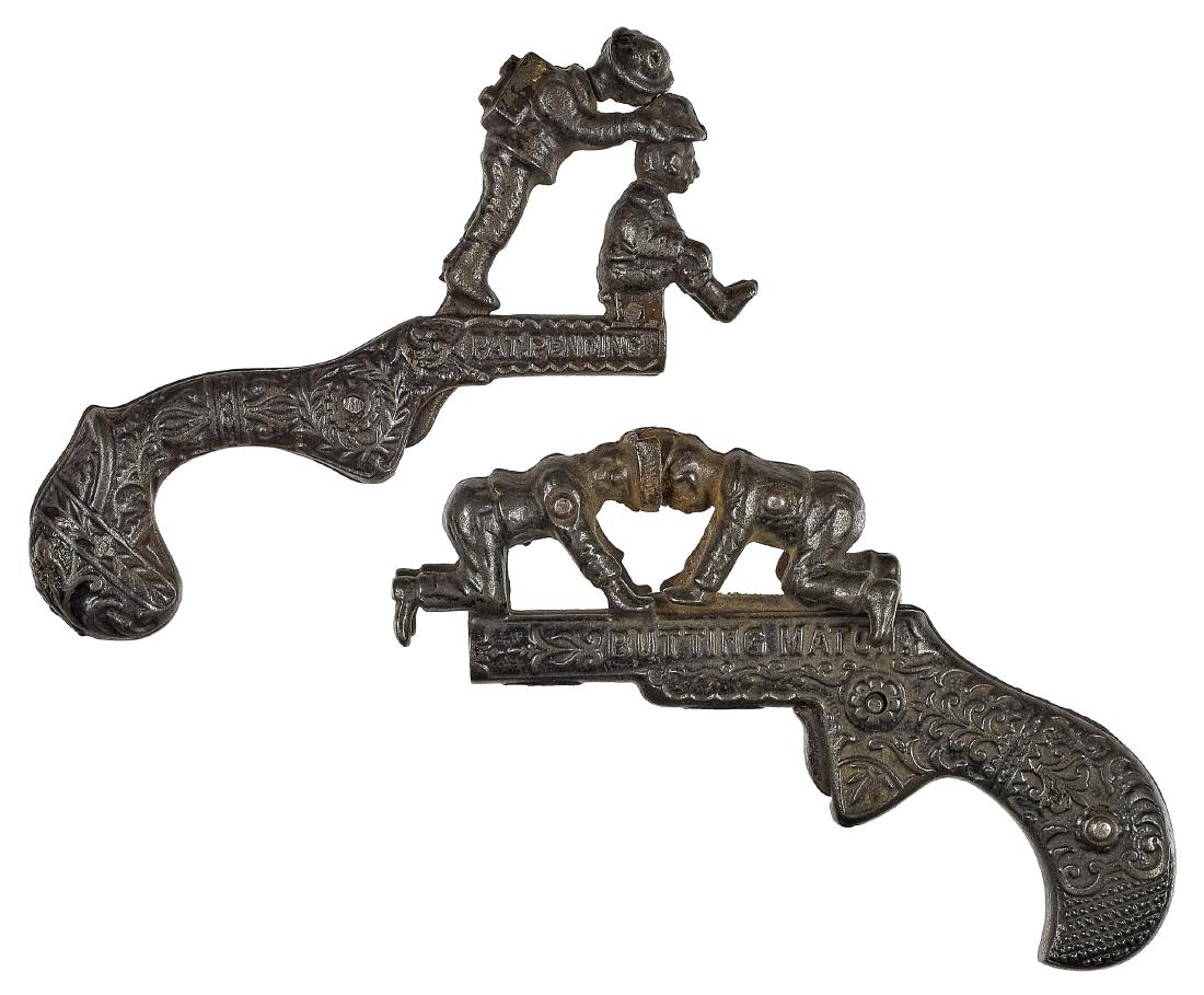 Two cast iron animated cap guns: Two cast iron animated cap guns, with embossed frames and grips, to include Butting Match, 5'' l., and Shoot the Hat, 4 3/4'' l.