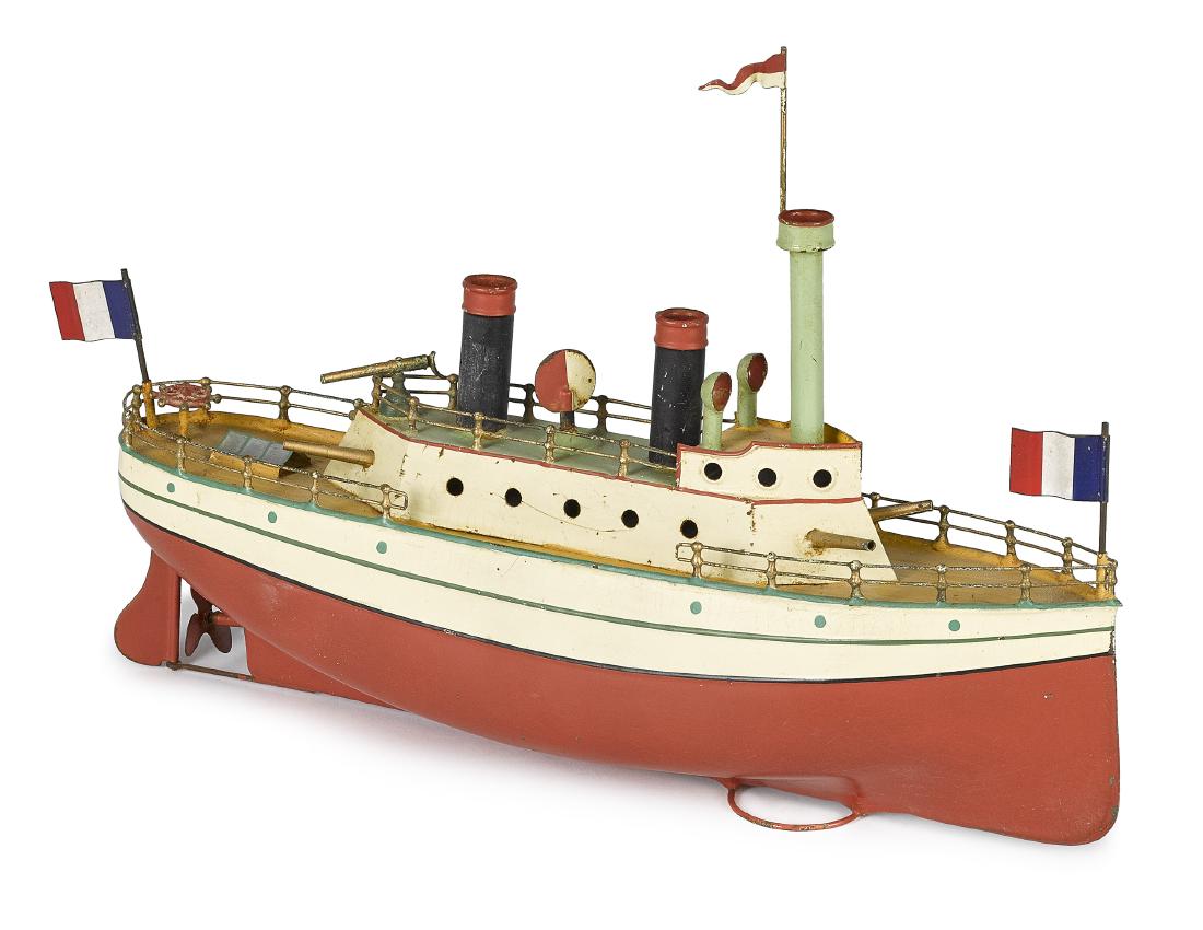 Carette painted tin clockwork gunboat: Carette painted tin clockwork gunboat, with two stacks, four cannons, and swivel gun, with fore and aft French flags, 13'' l. Provenance: Bill and Stevie Weart Collection.