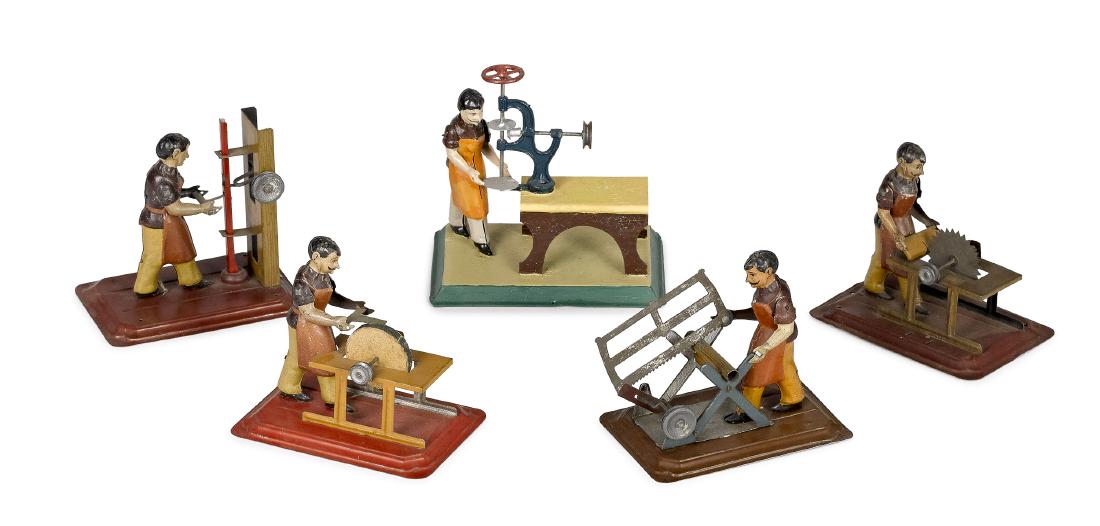 Five Arnold workmen steam toy accessories: Five Arnold painted tin workmen steam toy accessories, to include two sawyers, a grinder, a stamper and a drill press, largest - 5 1/4'' h., 5 1/4'' w., 3 1/2'' d. Pictured in Morton A. Hirschberg Ste
