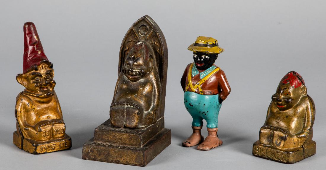 Four cast iron still banks: Four cast iron still banks, to include Do You Know Me gnome bank, sharecropper, Billiken and Billikin Good Luck on throne, tallest - 6 1/2''.