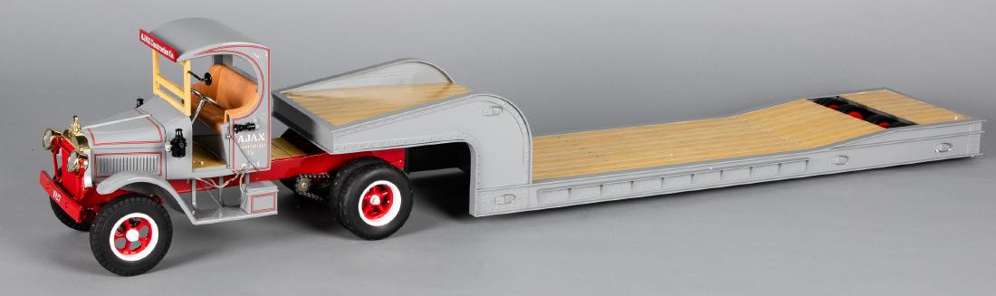 Retro pressed steel model tractor trailer lowboy: Retro 1, 2, 3 pressed steel scale model Ajax Construction Co. tractor trailer lowboy, in the original box, 55'' l.