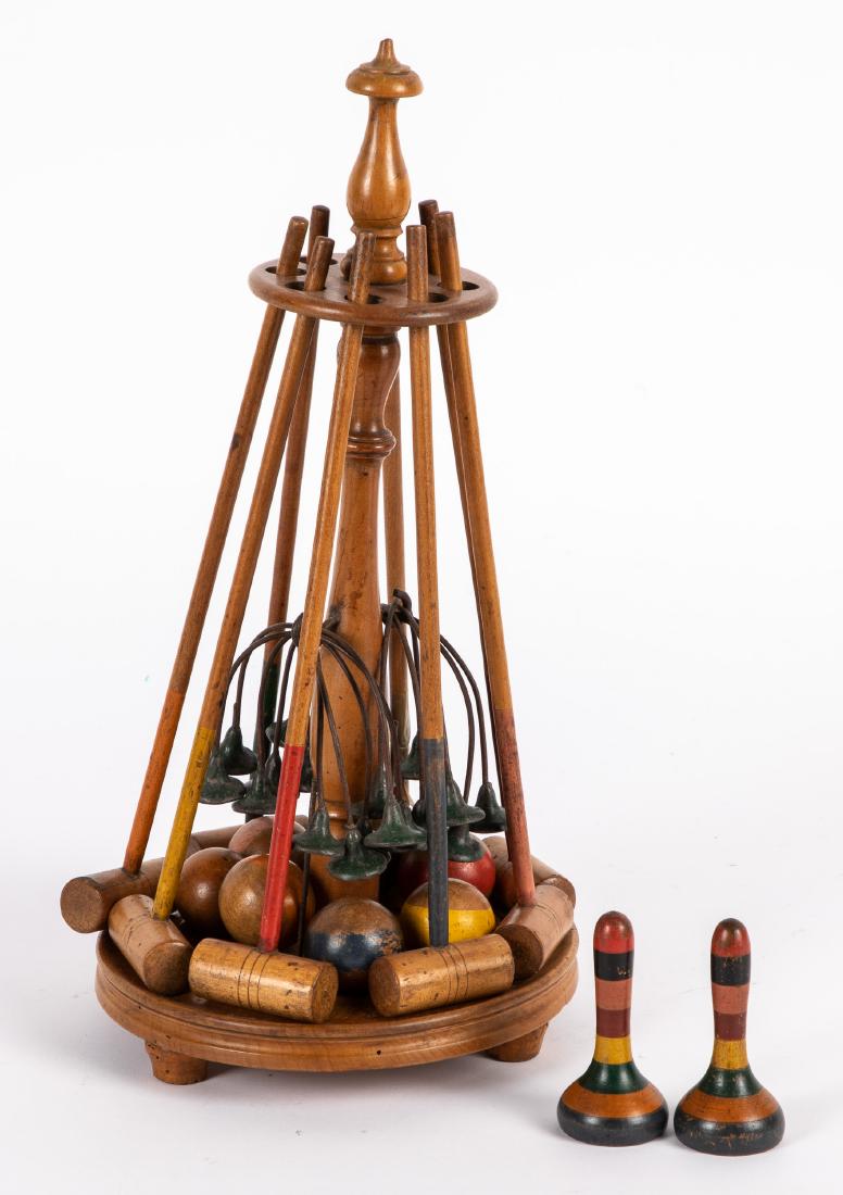 Parlor table top croquet set: Parlor table top croquet set, in stand, with eight mallets, ten metal wickets, seven balls, and two striped goal stakes, stand - 14 1/4'' h.