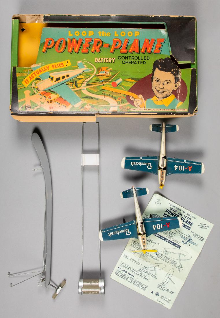 Japanese G. W. tin lithograph plane: Japanese G. W. tin lithograph battery operated Loop the Loop Power Plane, in the original box, with two Beechcraft airplanes, 8 1/2'' wingspan. Provenance: Estate of Jonathan Barrow, Los Angeles, Cali