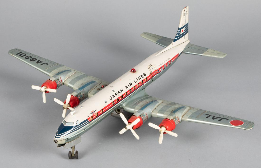 Japanese Yonezawa tin lithograph friction airplane: Japanese Yonezawa tin lithograph battery operated Japan Air Lines DC-7C friction airplane, 23 1/2'' wingspan. Provenance: Estate of Jonathan Barrow, Los Angeles, California.