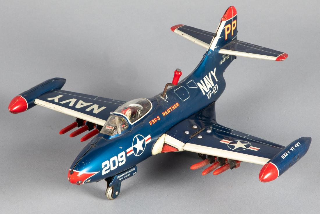 Japanese Yonezawa tin lithograph friction airplane: Japanese Yonezawa tin lithograph F9F-5 Panther Navy friction airplane with folding bomb laden wings, 12 1/4'' wingspan. Provenance: Estate of Jonathan Barrow, Los Angeles, California.