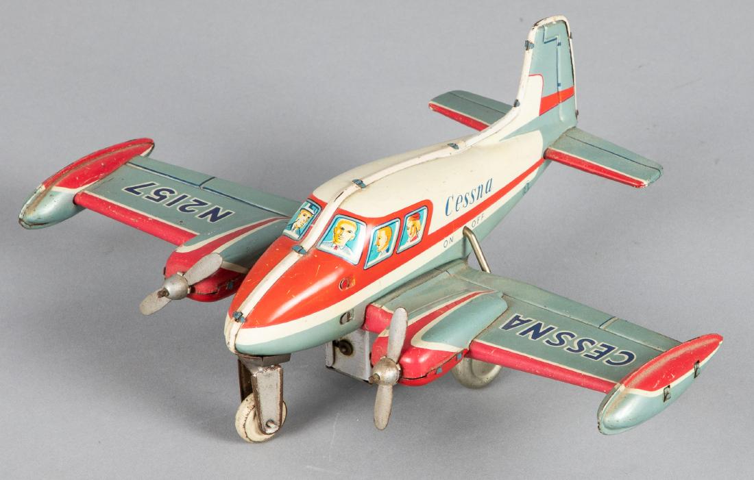 Japanese tin lithograph battery operated airplane: Japanese tin lithograph battery operated Cessna N2157 friction airplane, 9 3/4'' wingspan. Provenance: Estate of Jonathan Barrow, Los Angeles, California.