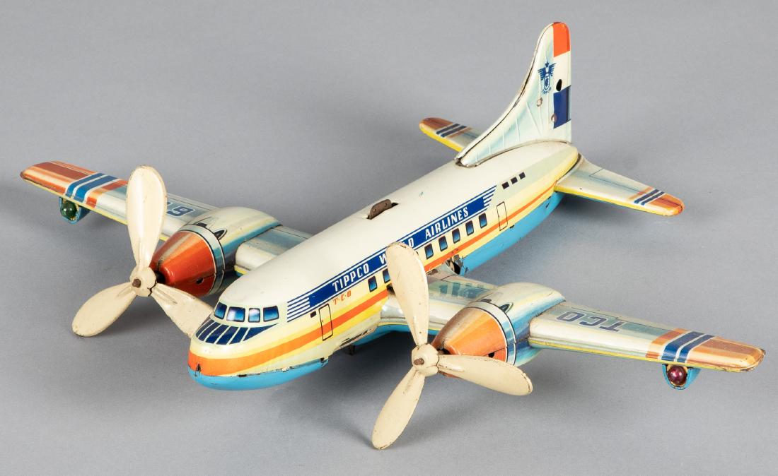 Tipp & Co. tin lithograph wind-up airplane: Tipp & Co. tin lithograph wind-up Tippco World Airlines airplane, 14 3/4'' wingspan. Provenance: Estate of Jonathan Barrow, Los Angeles, California.