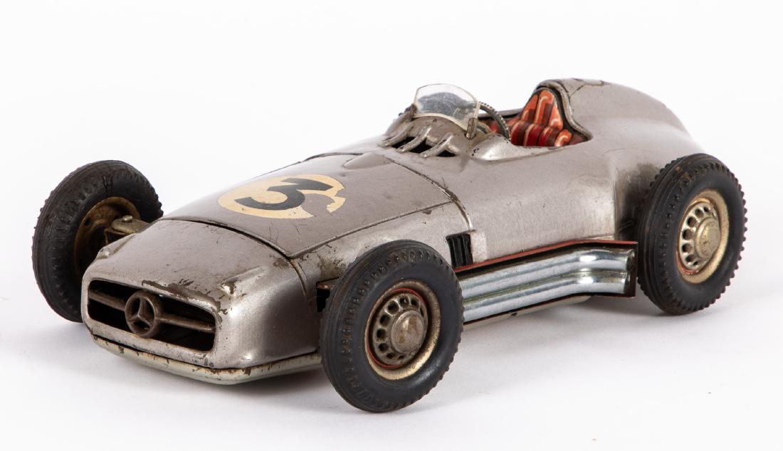Western Germany JNF tin lithograph Mercedes: Western Germany JNF tin lithograph battery operated Mercedes race car, 9 1/2'' l. Provenance: Estate of Jonathan Barrow, Los Angeles, California.