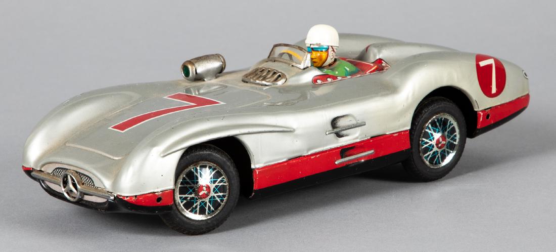Japanese tin Marusan battery operated Mercedes: Japanese tin Marusan battery operated Mercedes race car, with driver, 10 1/4'' l. Provenance: Estate of Jonathan Barrow, Los Angeles, California.