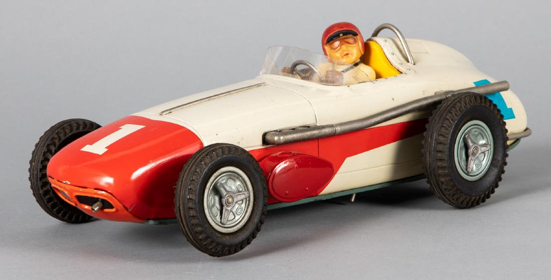 Japanese tin lithograph battery operated race car: Japanese tin lithograph battery operated Indianapolis 500 Racer car, with driver, 15 1/4'' l. Provenance: Estate of Jonathan Barrow, Los Angeles, California.