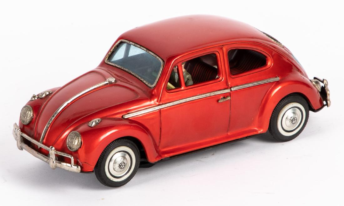 Japanese Bandai tin lithograph battery operated VW: Japanese Bandai tin lithograph battery operated Volkswagen, with visible engine, 10 1/2'' l. Provenance: Estate of Jonathan Barrow, Los Angeles, California.