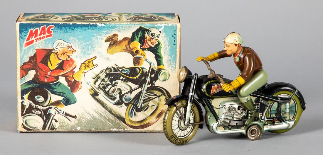 Arnold lithograph clockwork daredevil motorcycle: Arnold tin lithograph clockwork MAC 700 daredevil motorcycle, with a reproduction box, complex action as rider gets off the motorcycle gets back on and goes, 7 1/2'' l. Provenance: Estate of Jonathan 