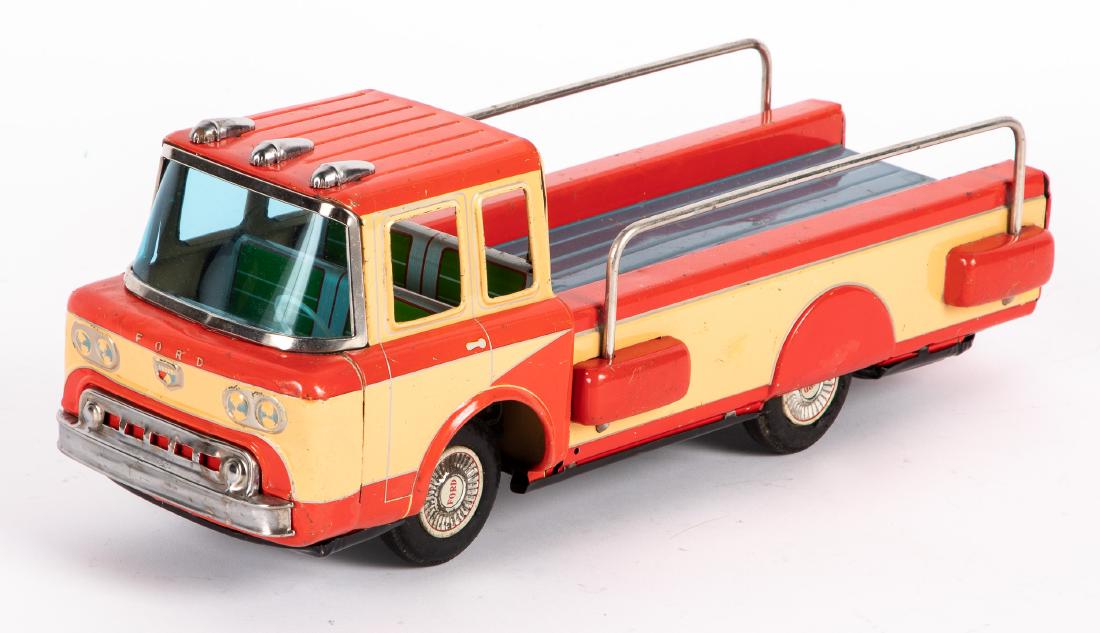 Japanese Yonezawa tin friction Ford flatbed truck: Japanese Yonezawa tin friction Ford flatbed pick-up truck, 15'' l. Provenance: Estate of Jonathan Barrow, Los Angeles, California.