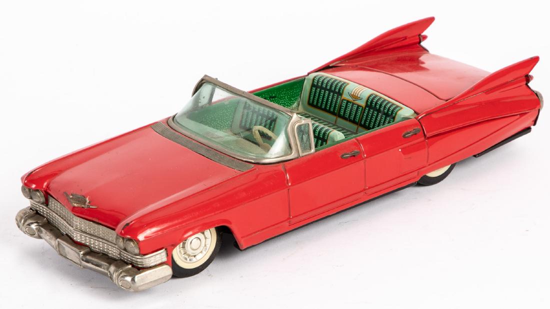 Japanese Bandai tin battery operated Cadillac: Japanese Bandai tin battery operated Cadillac convertible, 11 1/4'' l. Provenance: Estate of Jonathan Barrow, Los Angeles, California.