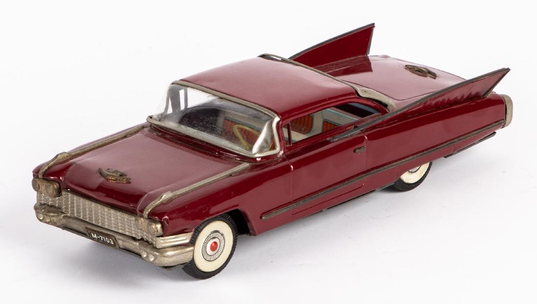 Japanese IY Metal Toys tin friction Cadillac: Japanese IY Metal Toys tin friction Cadillac, 11 1/2'' l. Provenance: Estate of Jonathan Barrow, Los Angeles, California.