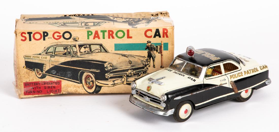 Japanese Marusan tin lithograph police car: Japanese Marusan tin lithograph battery operated Stop-Go Patrol Car police car, with original box, having a driver and passenger, 10 1/4'' l. Provenance: Estate of Jonathan Barrow, Los Angeles, Califo