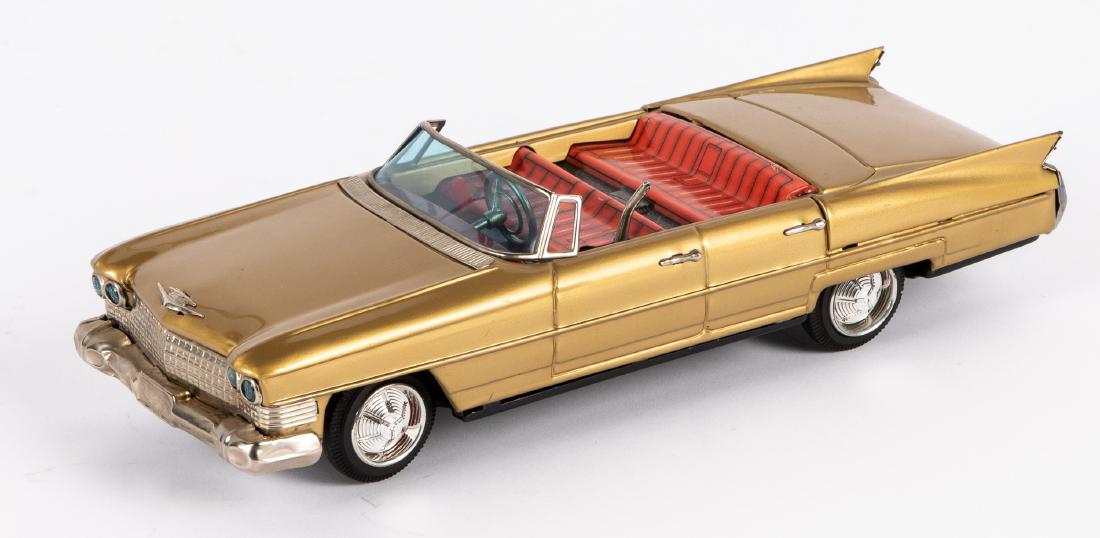 Japanese Bandai tin battery operated Cadillac: Japanese Bandai tin battery operated Cadillac convertible, with gear shift, 11 1/2'' l. Provenance: Estate of Jonathan Barrow, Los Angeles, California.