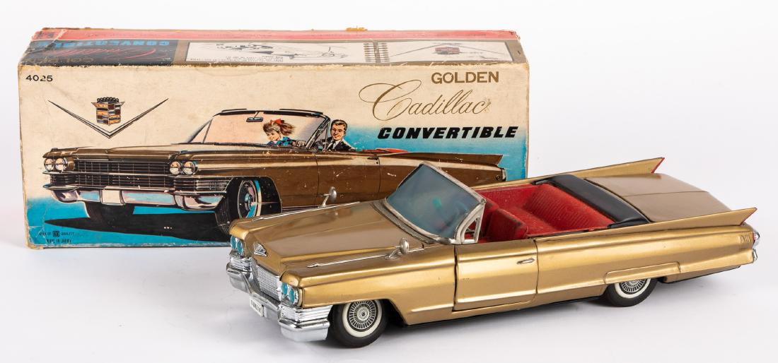 Japanese Bandai tin battery operated Cadillac: Japanese Bandai tin battery operated Golden Cadillac convertible, with the original box, 17'' l. Provenance: Estate of Jonathan Barrow, Los Angeles, California.