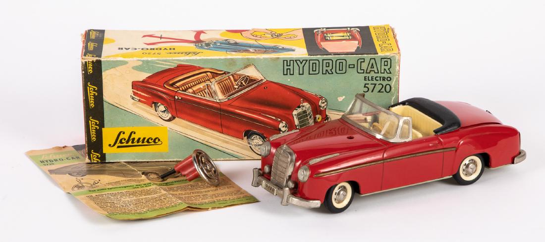 Schuco tin battery operated Mercedes: Schuco tin battery operated remote control Elektro Hydro-Car 5720 Mercedes convertible, with the original box with some accessories, seat lifts to reveal transmission, 10'' l. Provenance: Estate of Jo