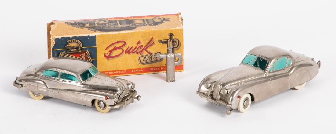 Two Prameta chrome wind-up cars: Two Prameta chrome wind-up cars, to include a Buick 405 sedan, with the original box, instructions and figural key, 5 1/2'' l., and a Kolnar Jaguar XK!20, 6'' l. Provenance: Estate of Jonathan Barrow,