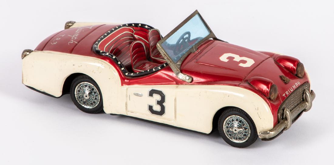Bandai lithograph tin friction Triumph race car: Bandai lithograph tin friction Triumph race car, 8 1/4'' l. Provenance: Estate of Jonathan Barrow, Los Angeles, California.