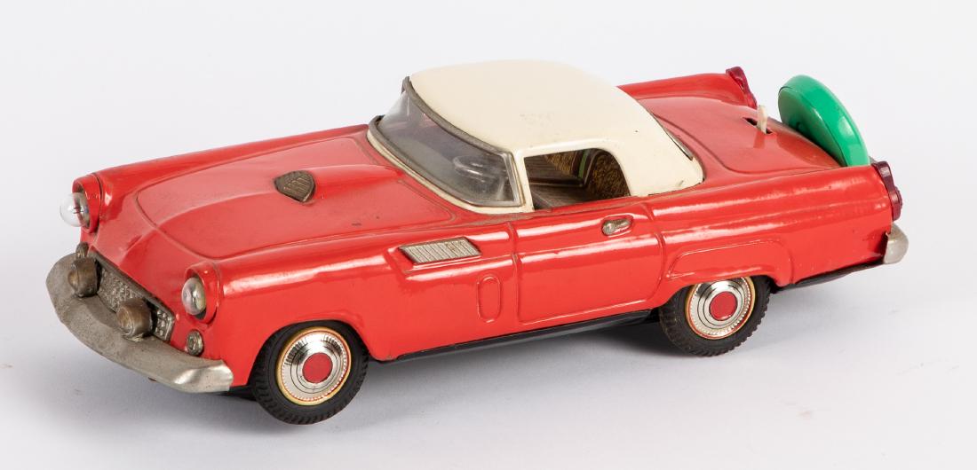 Japanese tin battery operated Ford Thunderbird: Japanese tin battery operated Ford Thunderbird, with headlights, 11'' l. Provenance: Estate of Jonathan Barrow, Los Angeles, California.