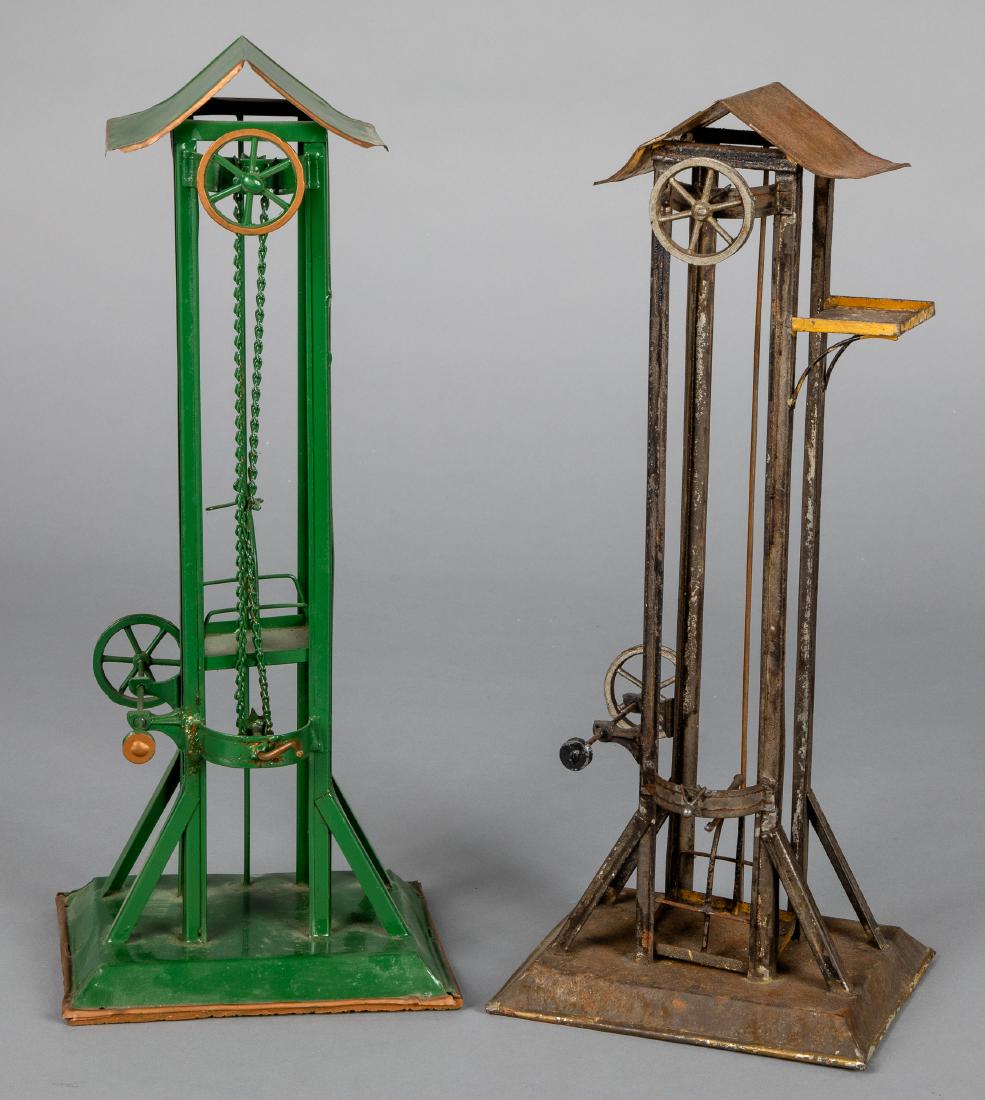 Two Bing painted tin freight elevator steam toys: Two Bing painted tin freight elevator steam toy accessories, 16 1/2'' h. Pictured in Morton A. Hirschberg Steam Toys - A Symphony in Motion, page 52. Provenance: Morton A. Hirschberg.