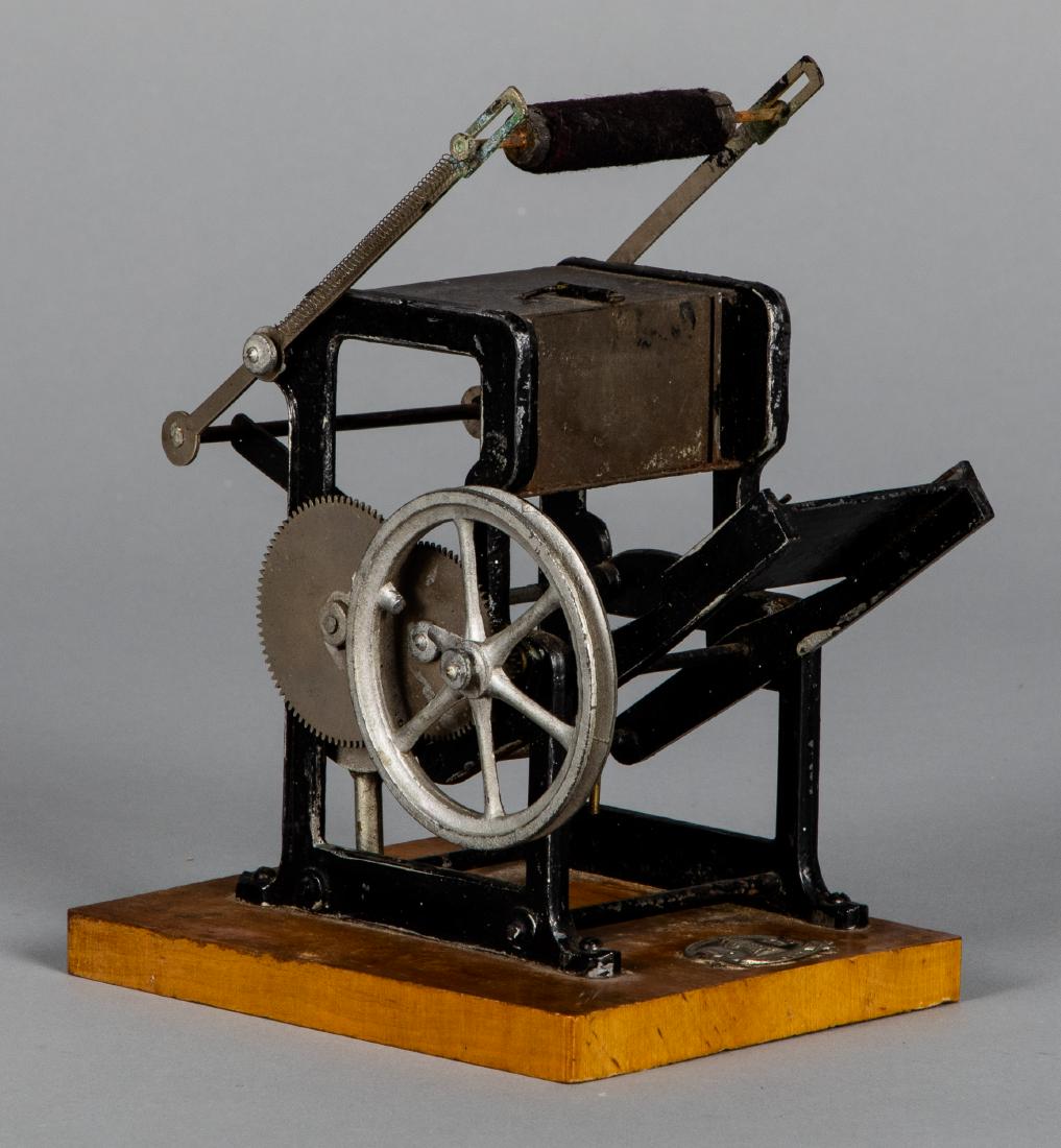 Falk iron printing press steam toy accessory: Falk iron printing press steam toy accessory, mounted to a wood base with company logo, 5 1/4'' h. Pictured in Morton A. Hirschberg Steam Toys - A Symphony in Motion, page 142. Provenance: Morton A. H