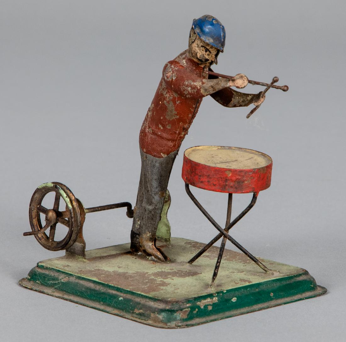 Becker painted tin snare drummer steam toy: Becker painted tin snare drummer steam toy accessory, 4 1/4'' h. Pictured in Morton A. Hirschberg Steam Toys - A Symphony in Motion, page 26. Provenance: Morton A. Hirschberg.