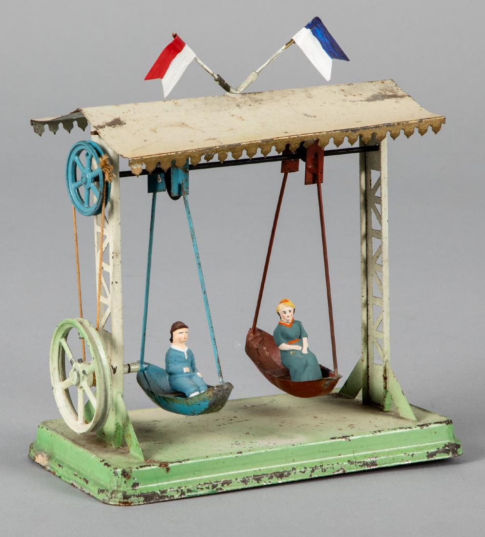 Falk painted tin boat swing steam toy accessory: Falk painted tin boat swing steam toy accessory, with composition riders, 7 3/4'' h., 7'' w. Pictured in Morton A. Hirschberg Steam Toys - A Symphony in Motion, page 138. Provenance: Morton A. Hirschb
