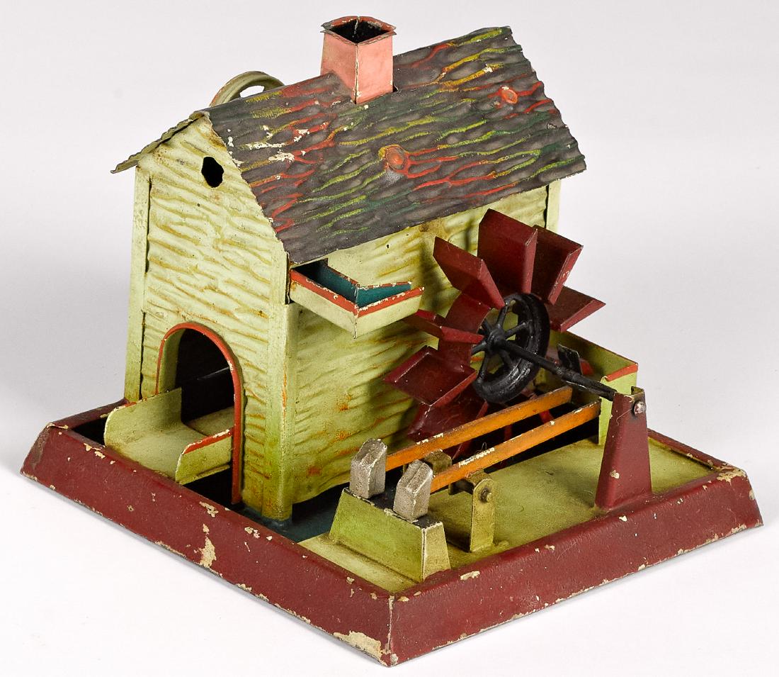 Doll & Cie painted and embossed tin mill steam toy: Doll & Cie painted and embossed tin mill steam toy accessory, with water wheel powered trip hammers, 5 1/2'' h., 6 1/2'' sq. Provenance: Morton A. Hirschberg Steam.