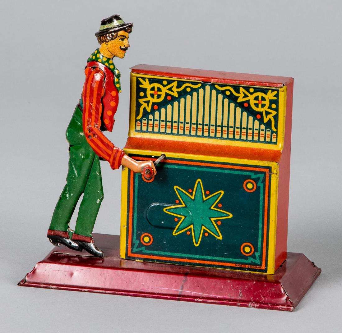 Tin lithograph organ grinder steam toy accessory: Tin lithograph organ grinder steam toy accessory, 6 3/4'' h. Provenance: Morton A. Hirschberg.