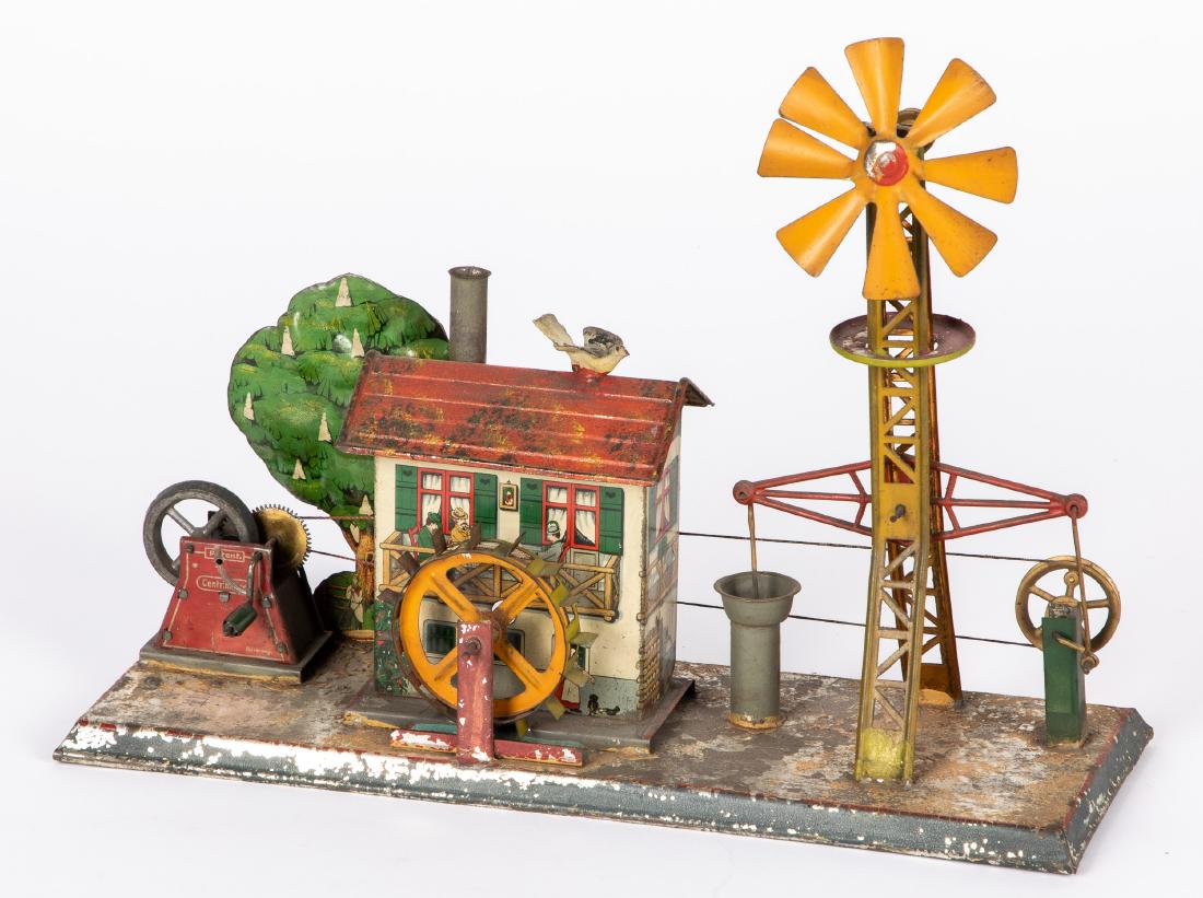 Mohr & Krauss waterworks steam toy accessory: Mohr & Krauss painted and lithograph tin waterworks steam toy accessory, with walking beam windmill, 10'' h. Pictured in Morton A. Hirschberg Steam Toys - A Symphony in Motion, page 172. Provenance: M