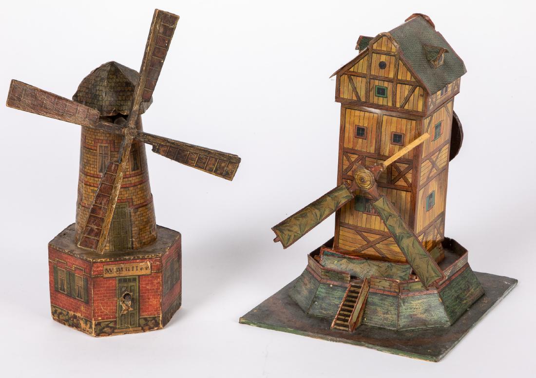Two lithograph windmill steam toy accessories: Two paper lithograph over wood and cardboard windmill steam toy accessories, tallest - 10 1/2''. Provenance: Morton A. Hirschberg.