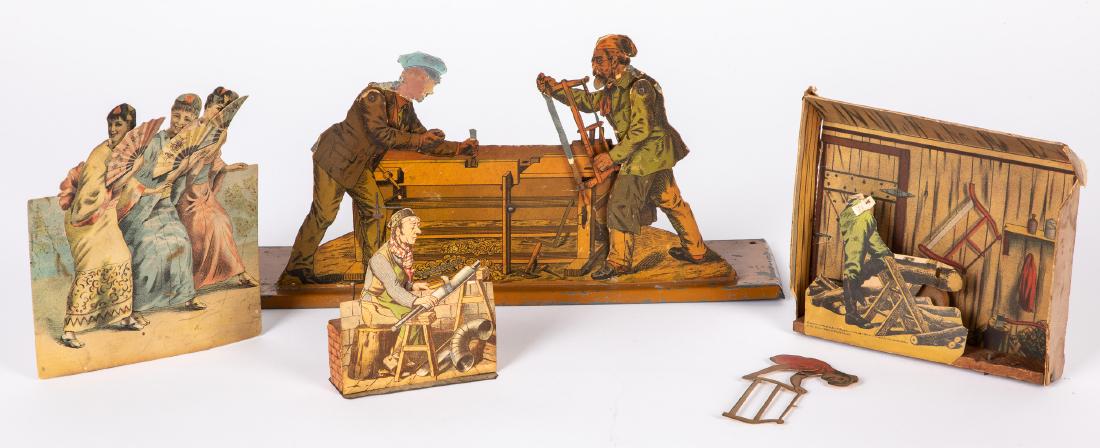 Four paper lithograph steam toy accessories: Four paper lithograph steam toy accessories, to include two woodworkers with paper over metal, an Ives sawyer, a pipe fitter, and a group of woman with hand fans, tallest - 7 1/4''. Provenance: Morton