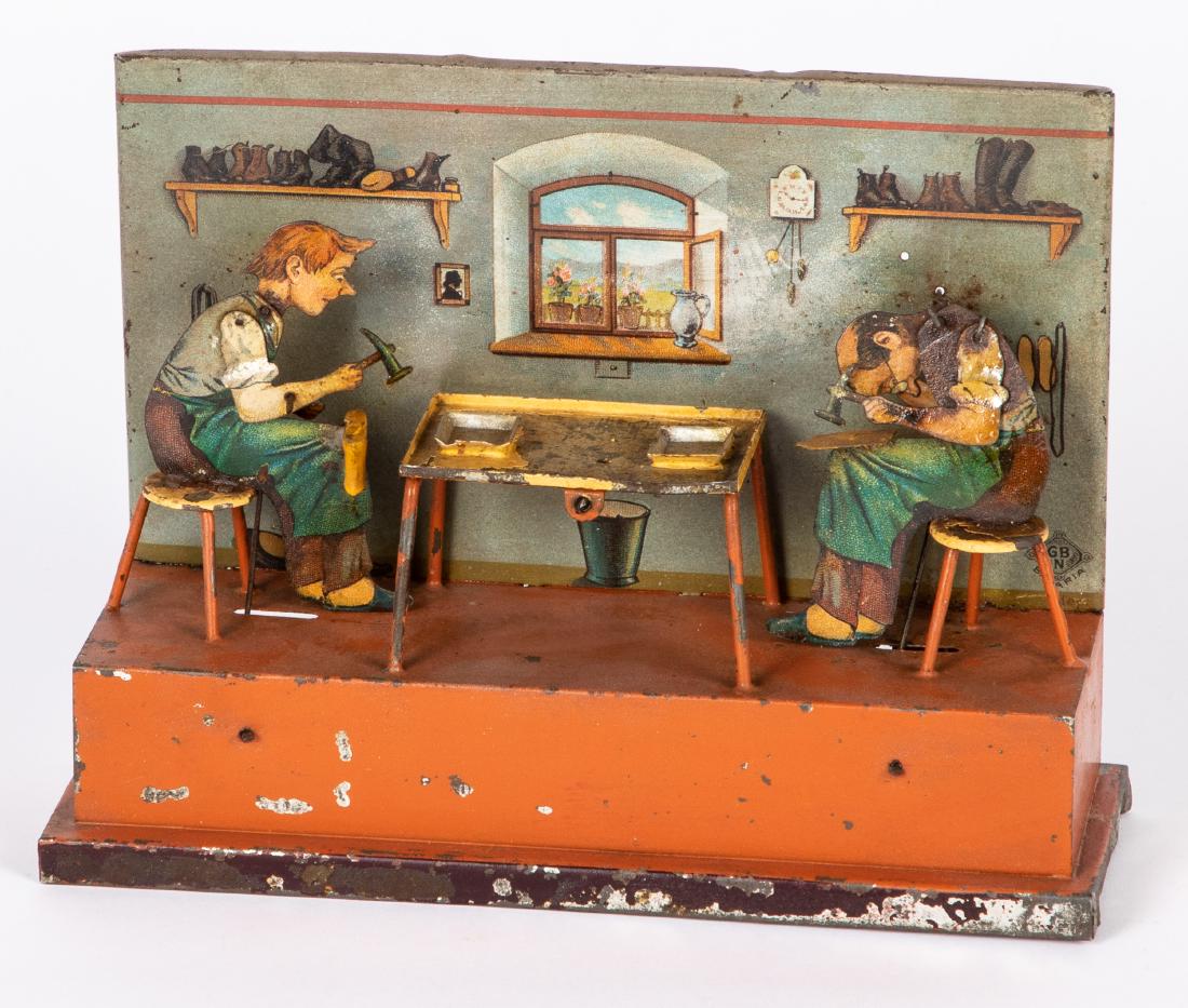 Bing tin lithograph cobbler steam toy accessory: Bing tin lithograph cobbler steam toy accessory, with two cobblers and a room background, 6 1/4'' h., 8 3/4'' w. Provenance: Morton A. Hirschberg.