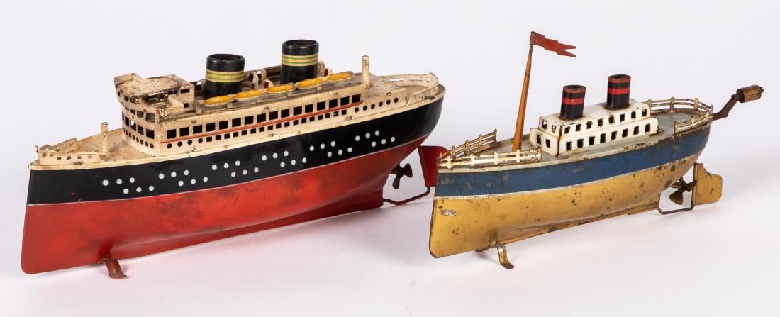 Two Arnold tin wind-up ocean liner boats: Two Arnold tin wind-up ocean liner boats, one 11'' l. and one hand crank, 9'' l.