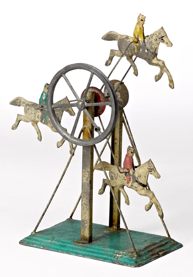 Carette Ferris wheel steam toy accessory: Carette painted tin Ferris wheel steam toy accessory, with three vertical horse and riders, 8'' h. Pictured in Morton A. Hirschberg Steam Toys - A Symphony in Motion, page 95. Provenance: Morton A. Hi