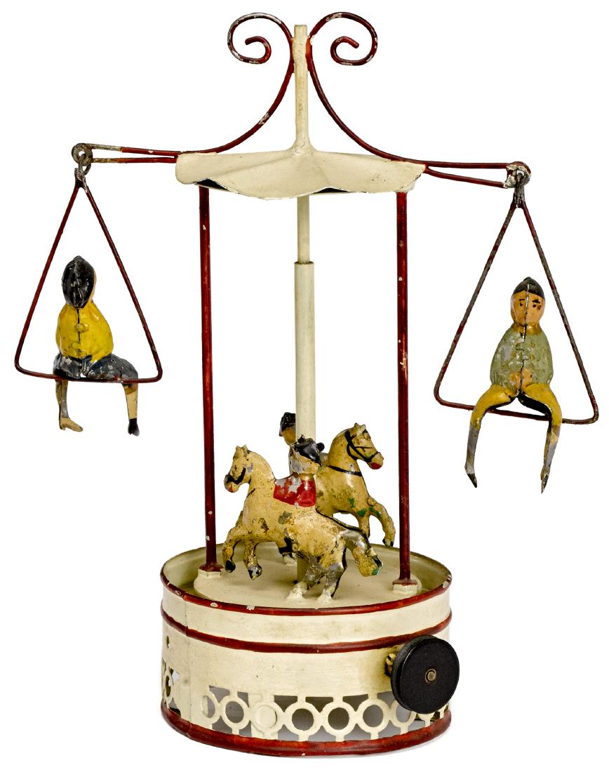 Painted tin carousel steam toy accessory: Painted tin carousel steam toy accessory, probably Carette, having two boys on swings with two figures on horseback below, 9 1/4'' h. Pictured in Morton A. Hirschberg Steam Toys - A Symphony in Motion
