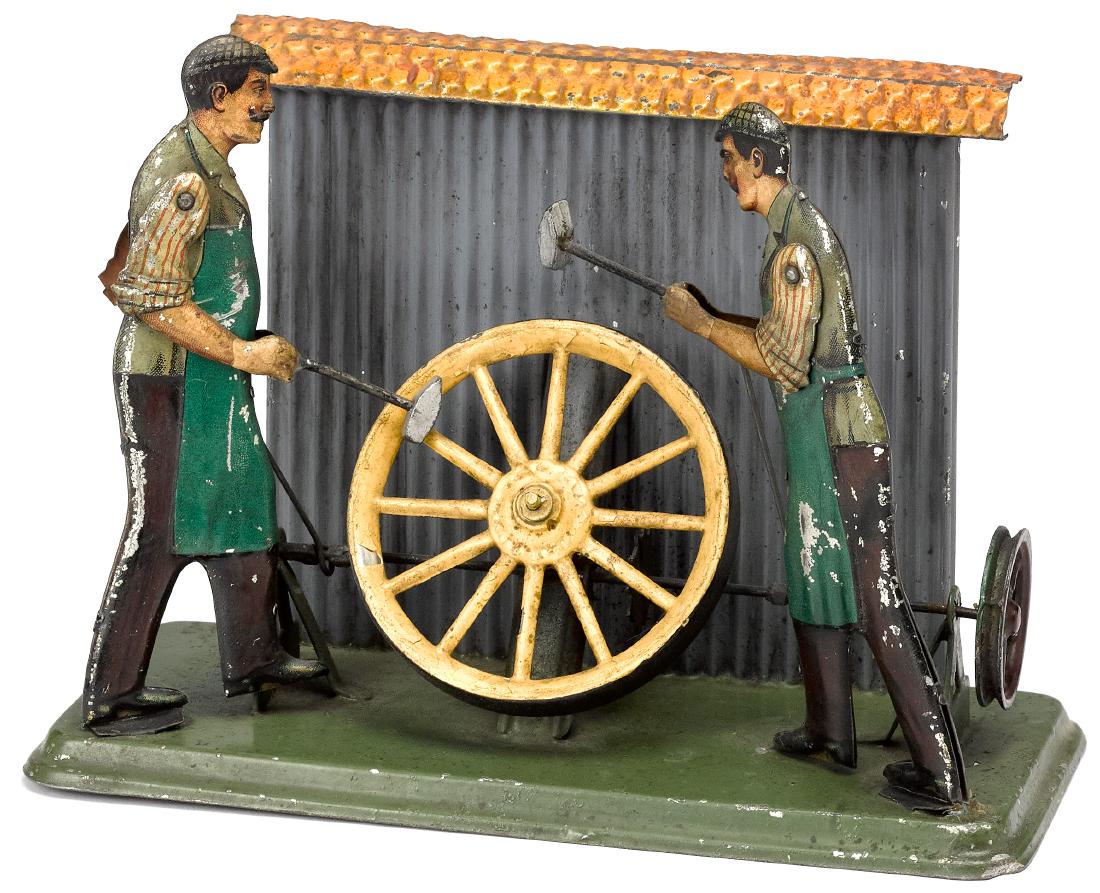 Bing wheelwrights steam toy accessory: Bing tin lithograph wheelwrights steam toy accessory, #9956/358, 5 1/2'' h., 7 3/4'' w. Pictured in Morton A. Hirschberg Steam Toys - A Symphony in Motion, page 40. Provenance: Morton A. Hirschberg St