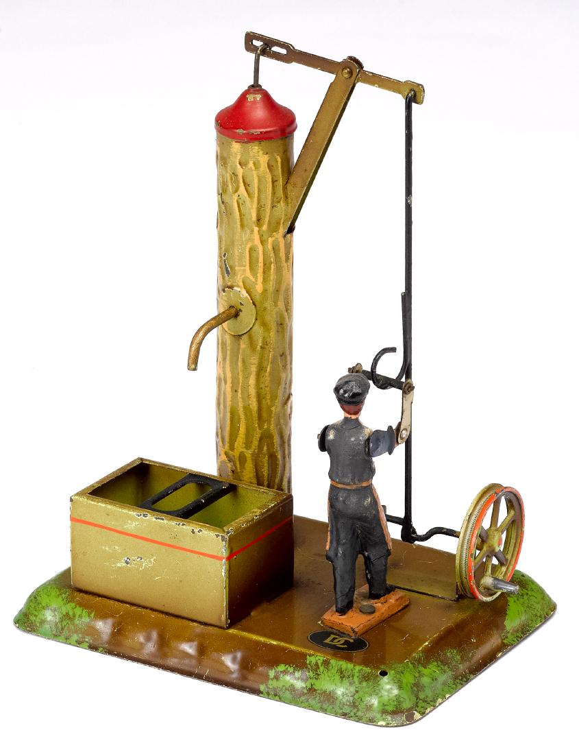 Doll painted tin man at pump steam toy accessory: Doll painted tin man at pump steam toy accessory, #758, 7 1/4'' h. Pictured in Morton A. Hirschberg Steam Toys - A Symphony in Motion, page 112. Provenance: Morton A. Hirschberg Steam Toy Collection.