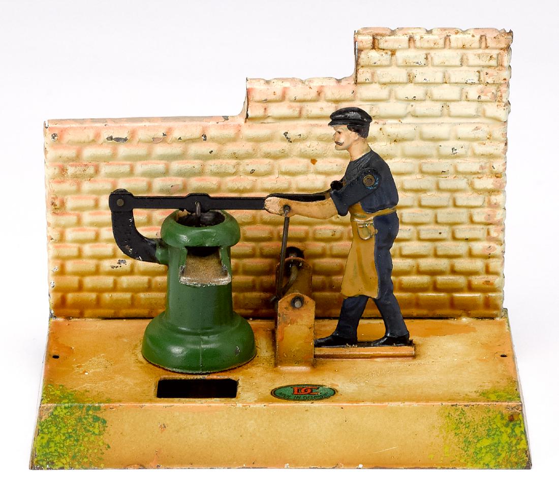 Doll painted tin man at pump steam toy accessory: Doll painted tin man at pump steam toy accessory, #926, 4 1/2'' h., 6'' w. Pictured in Morton A. Hirschberg Steam Toys - A Symphony in Motion, page 117. Provenance: Morton A. Hirschberg Steam Toy Coll